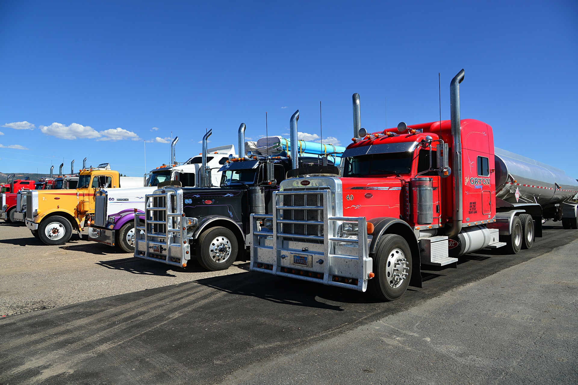 A few semi trucks lined up in a row