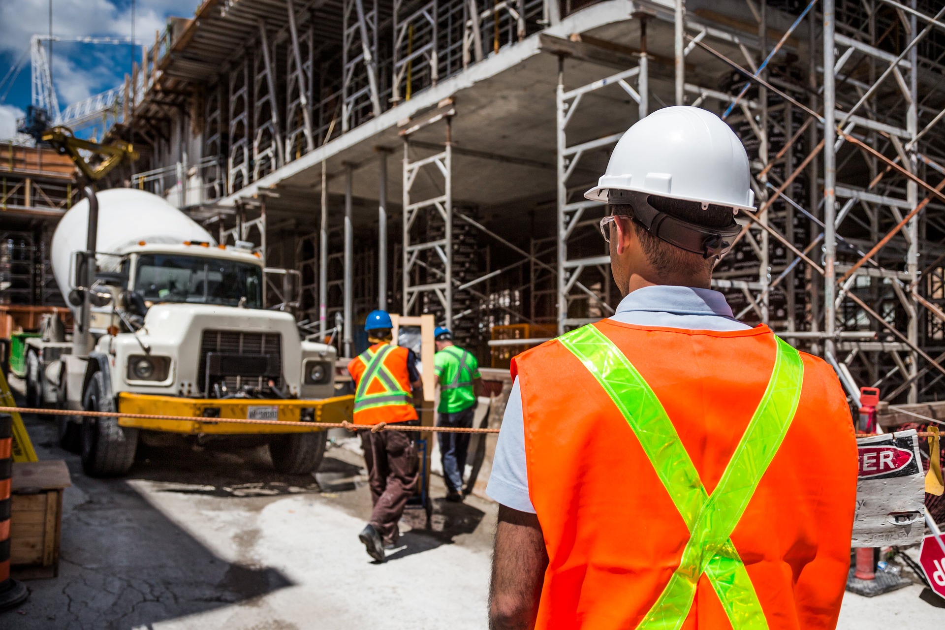 Man in a construction vest staring at truck