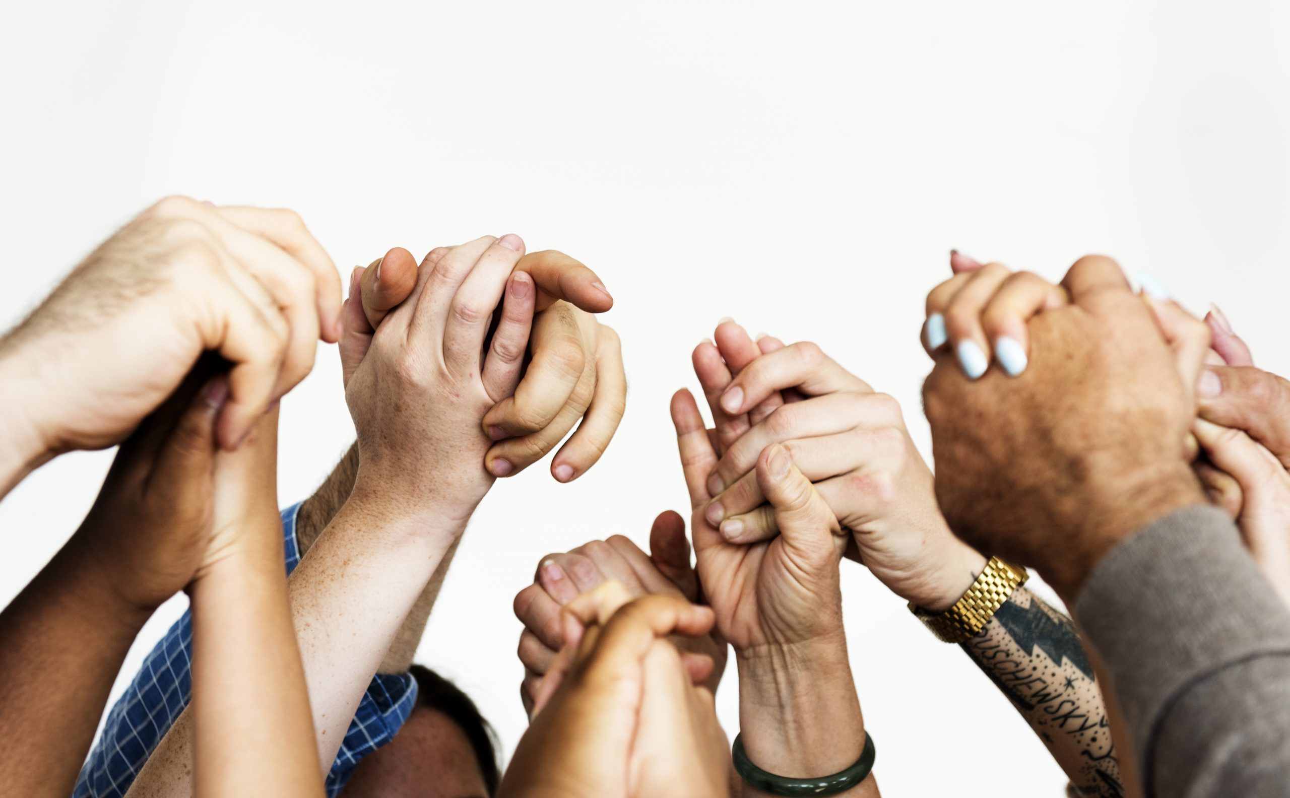 closeup of multiracial people holding hands