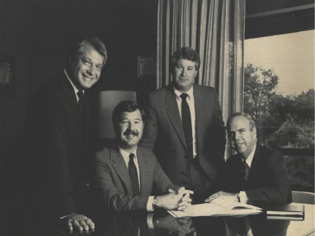 A group of men looking at the camera and smiling