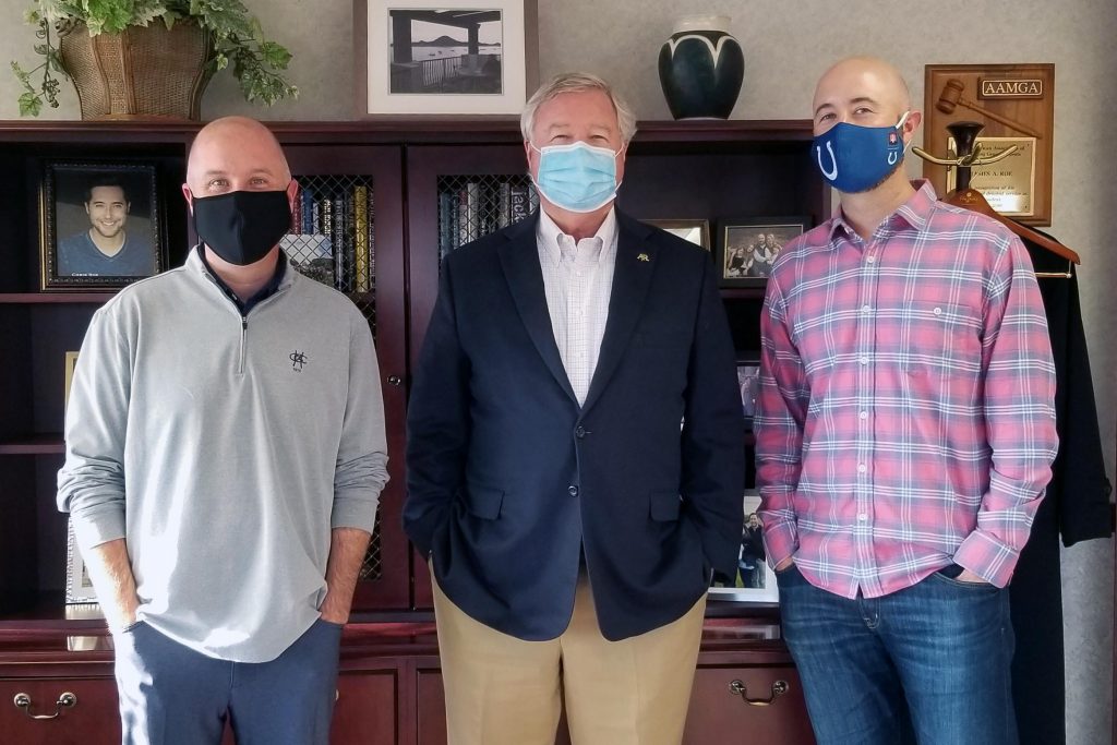image of three Roes with masks on smiling at the camera
