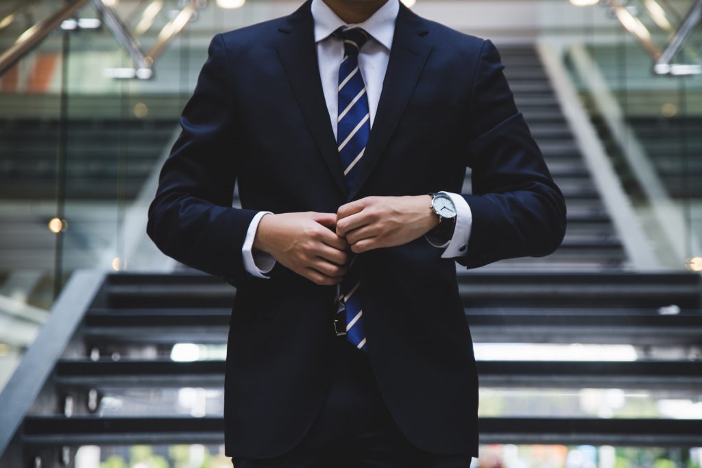 Business man in suit in front of stairs