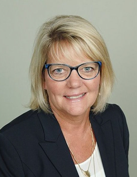 headshot of Debbie smiling into the camera