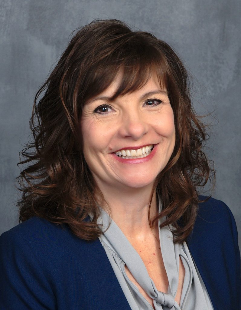 headshot of Sue Sutphen smiling into the camera