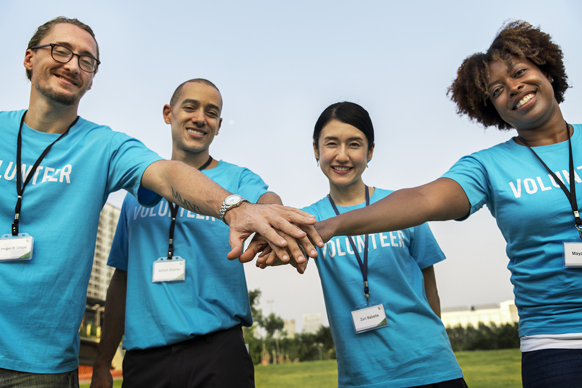 Team of volunteers stacking hands