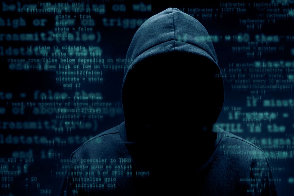 image of a hooded person with a code background