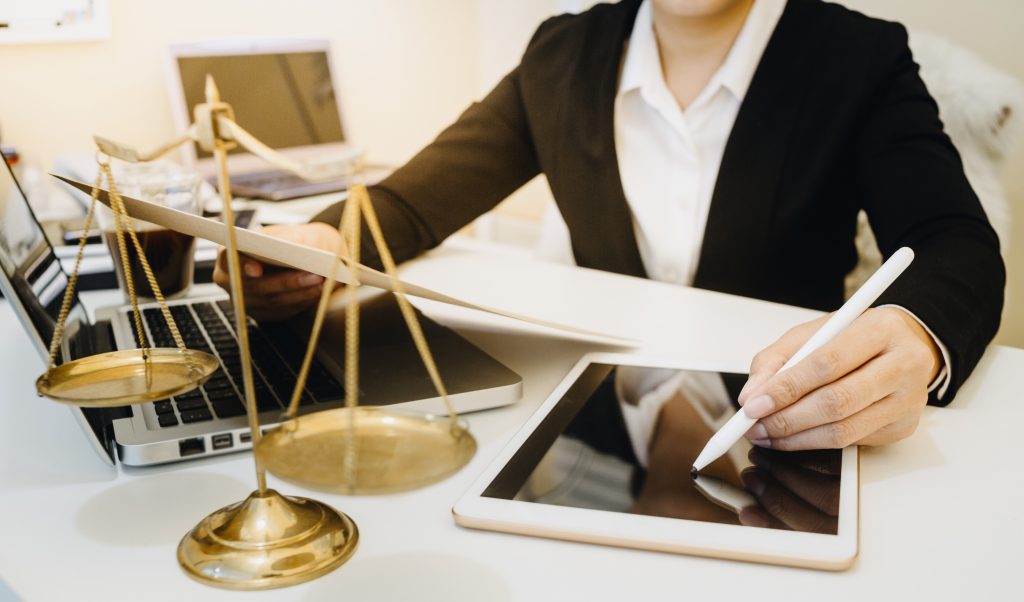 Male judge in a courtroom on wooden table and Counselor or Male lawyer working in office. Legal law, advice and justice concept.