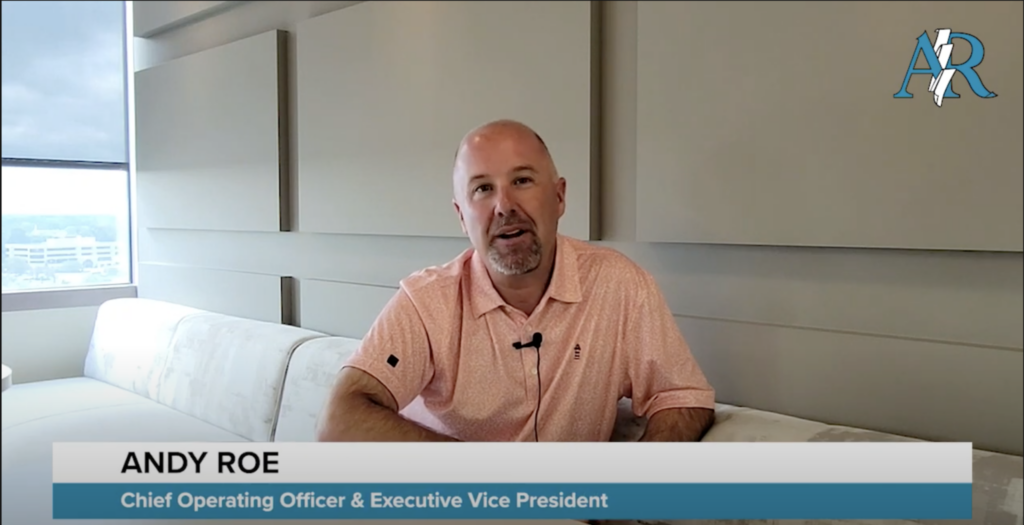 an image of a man sitting on a sofa in a corporate building